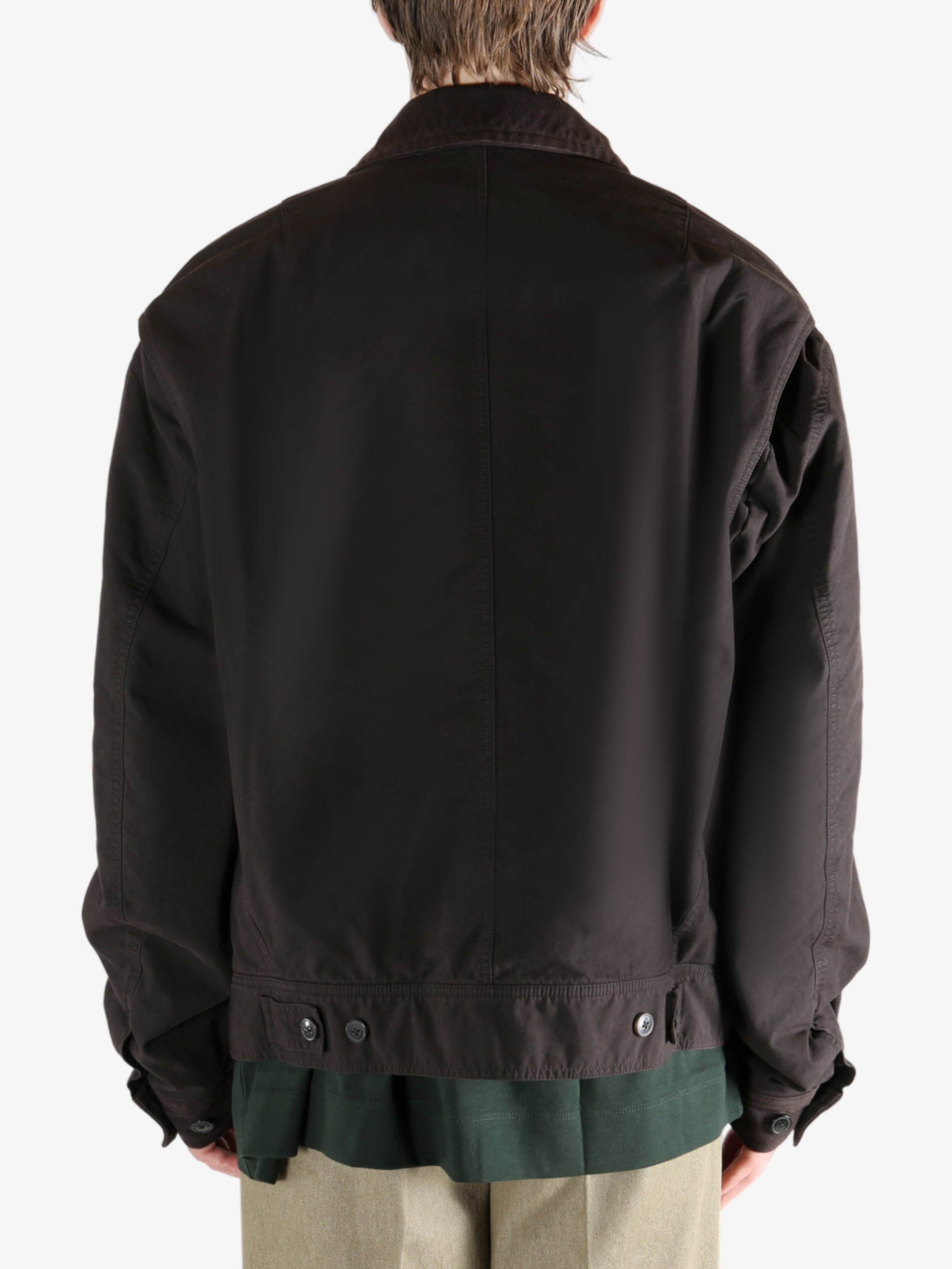 Brown jacket worn by a person, showing the jacket's fit