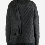 Grey knitwear worn by a person, showing the knitwear fit