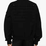 Black jacket worn by a person, showing the jacket's fit