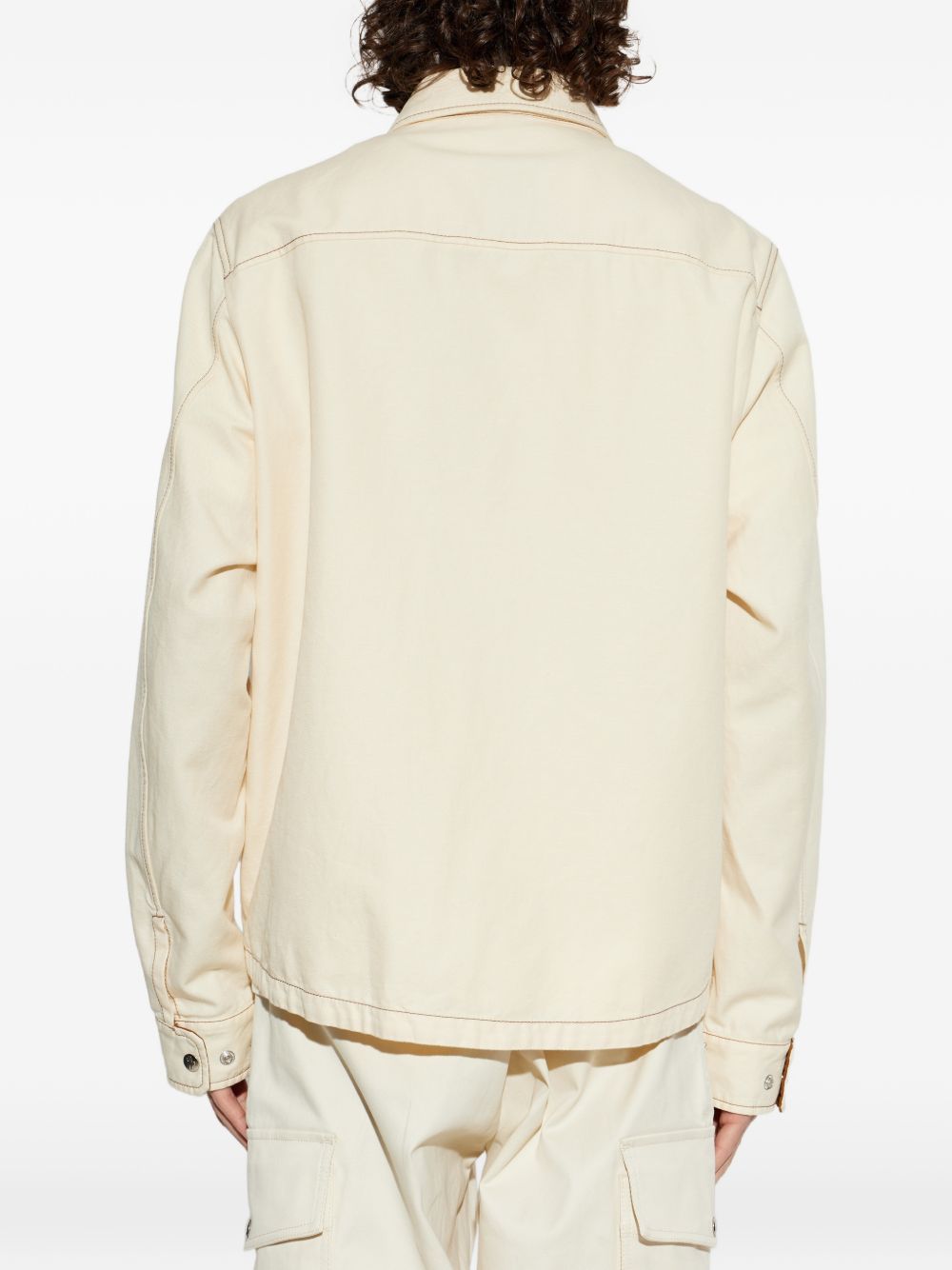 beige jacket worn by a person, showing the jacket fit