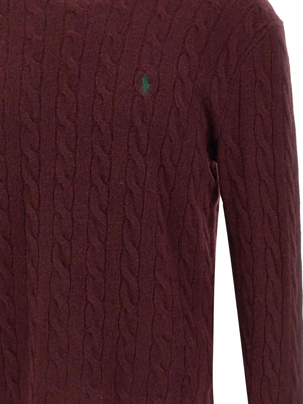 Close up of red knitwear, showing texture of the wool fabric