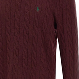 Close up of red knitwear, showing texture of the wool fabric