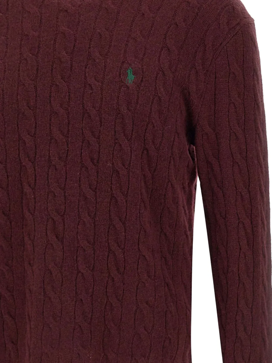 Close up of red knitwear, showing texture of the wool fabric
