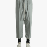 Grey pants worn by a person, showing the pants fit