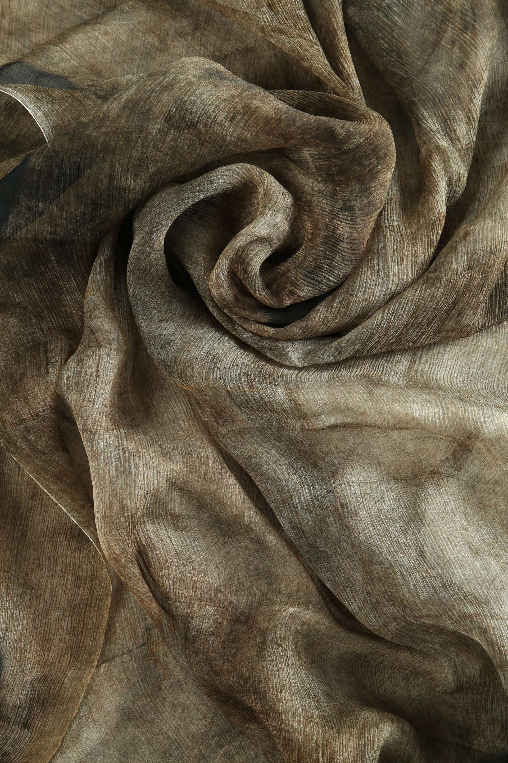 Close up of brown scarf, showing texture of the Silk fabric