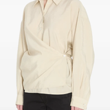 White shirt worn by a person, showing the shirt's fit