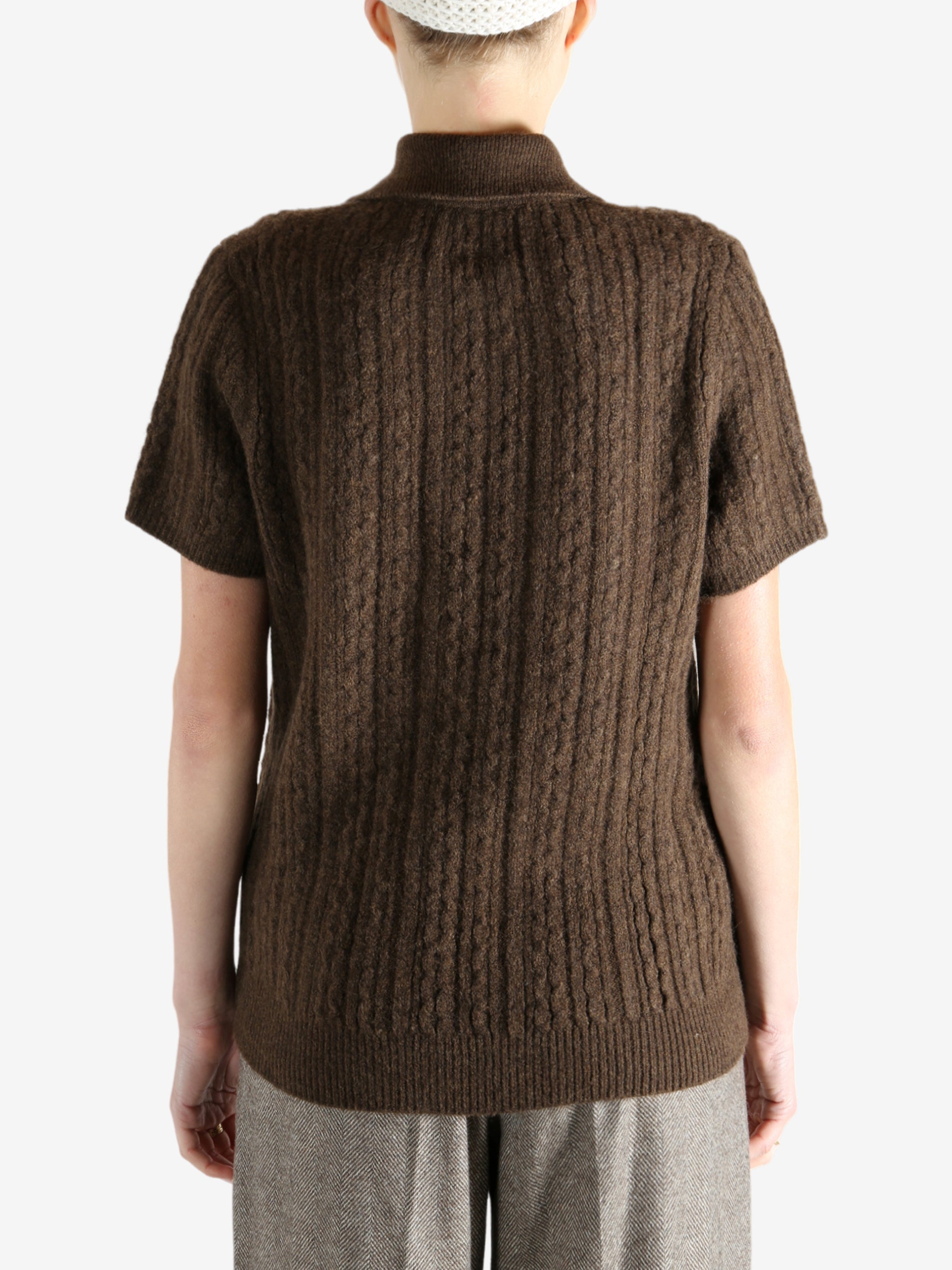 Brown knitwear worn by a person, showing the knitwear fit