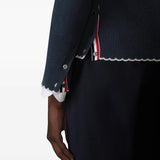 Close up of navy cardigan, showing texture of the wool fabric