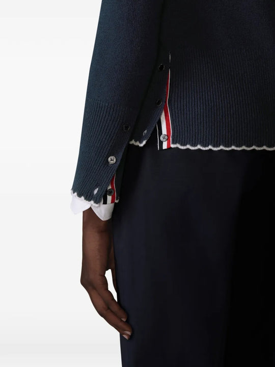 Close up of navy cardigan, showing texture of the wool fabric