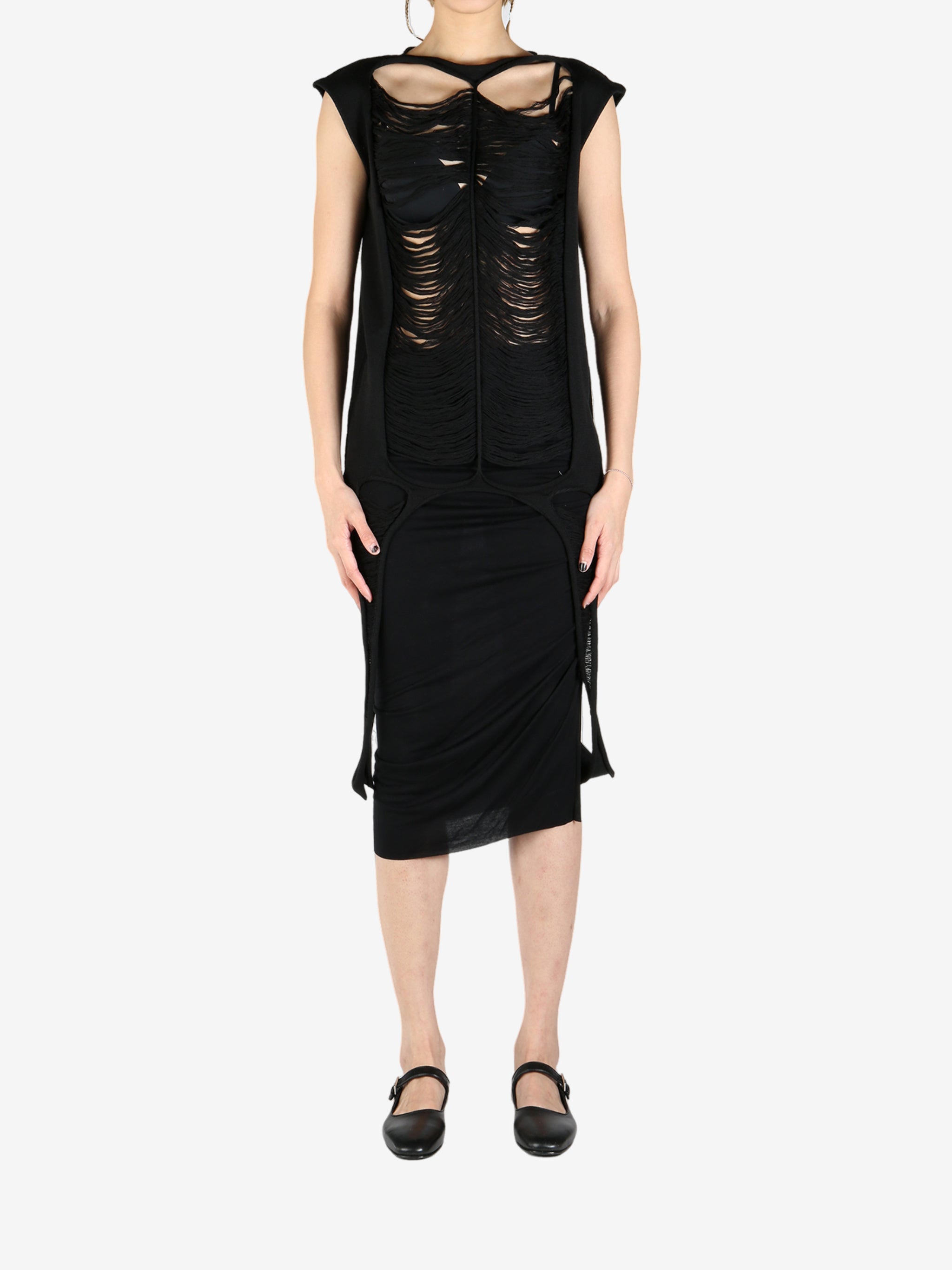 Black top worn by a person, showing the top's fit