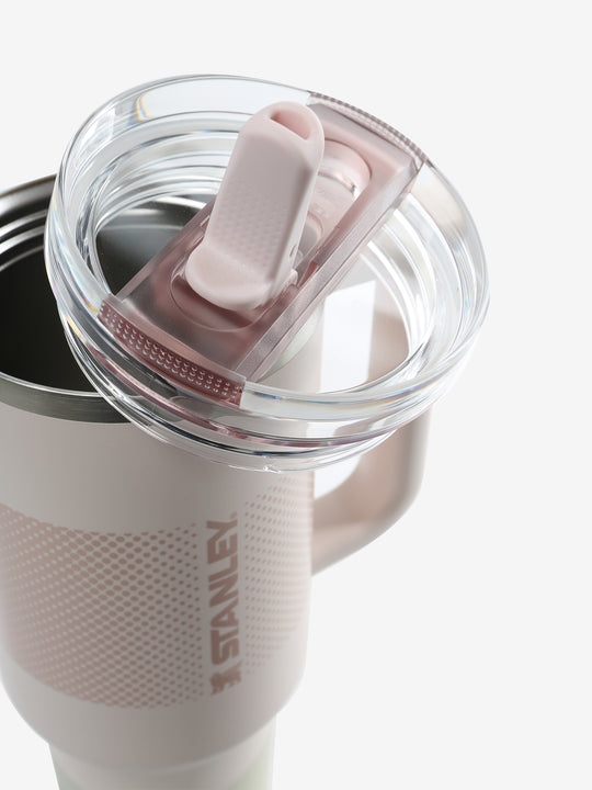Close up of pink tumbler, showing texture of the clear lid and straw
