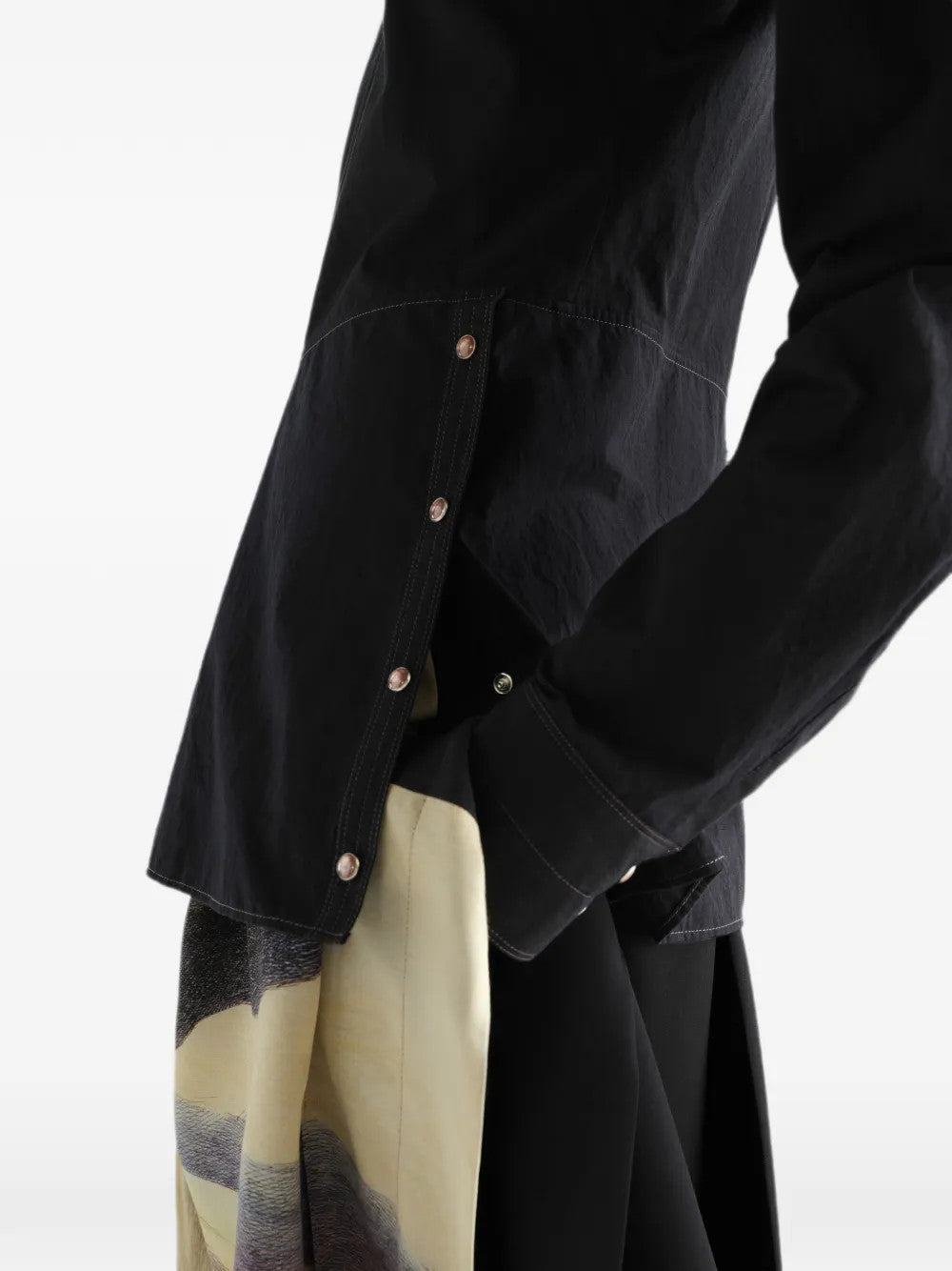 Black top worn by a person, showing the top fit