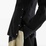 Black top worn by a person, showing the top fit