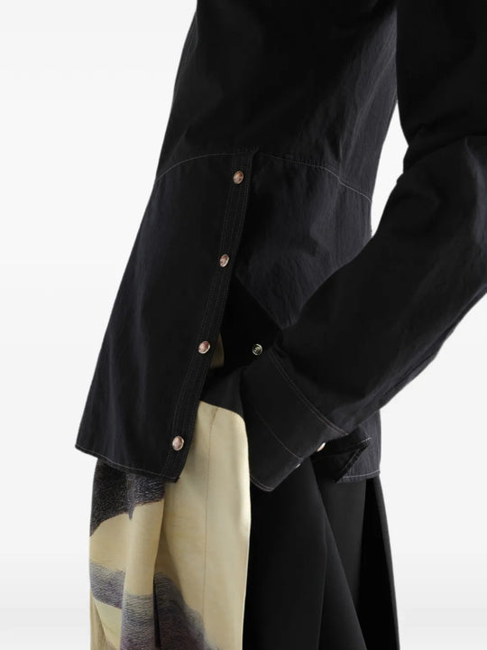 Black top worn by a person, showing the top fit