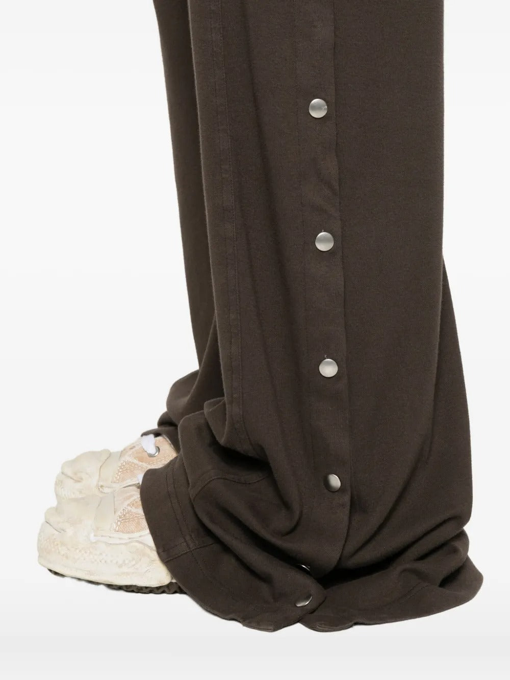 Close up of the brown pants, showing texture of the cotton fabric