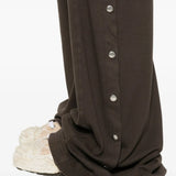 Close up of the brown pants, showing texture of the cotton fabric