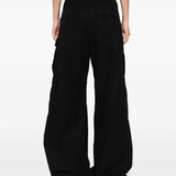 Black pants worn by a person, showing the pants fit