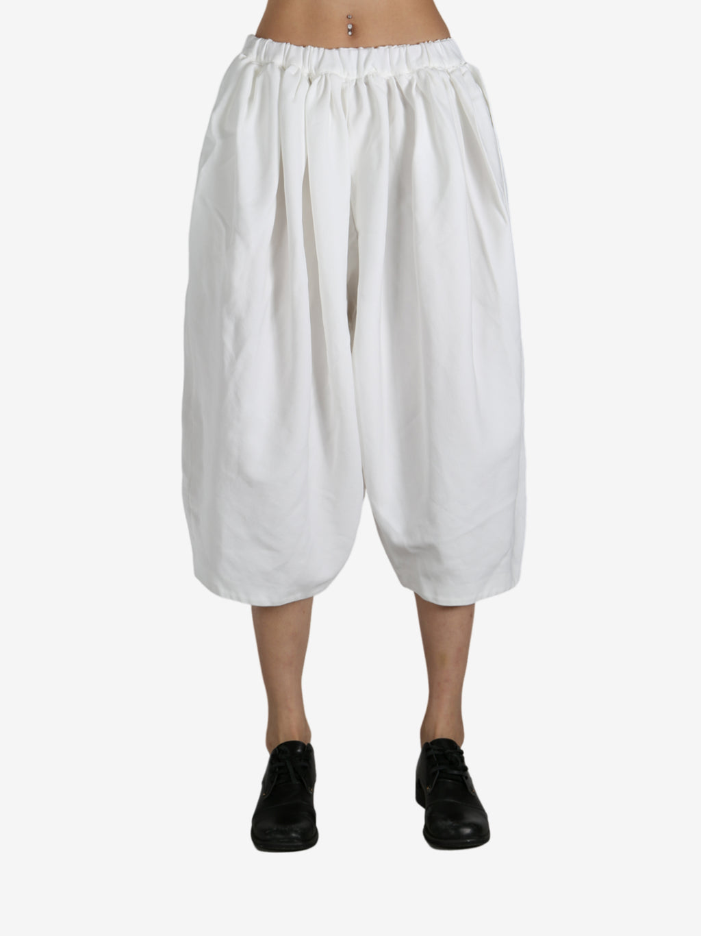 White pants worn by a person, showing the pants fit