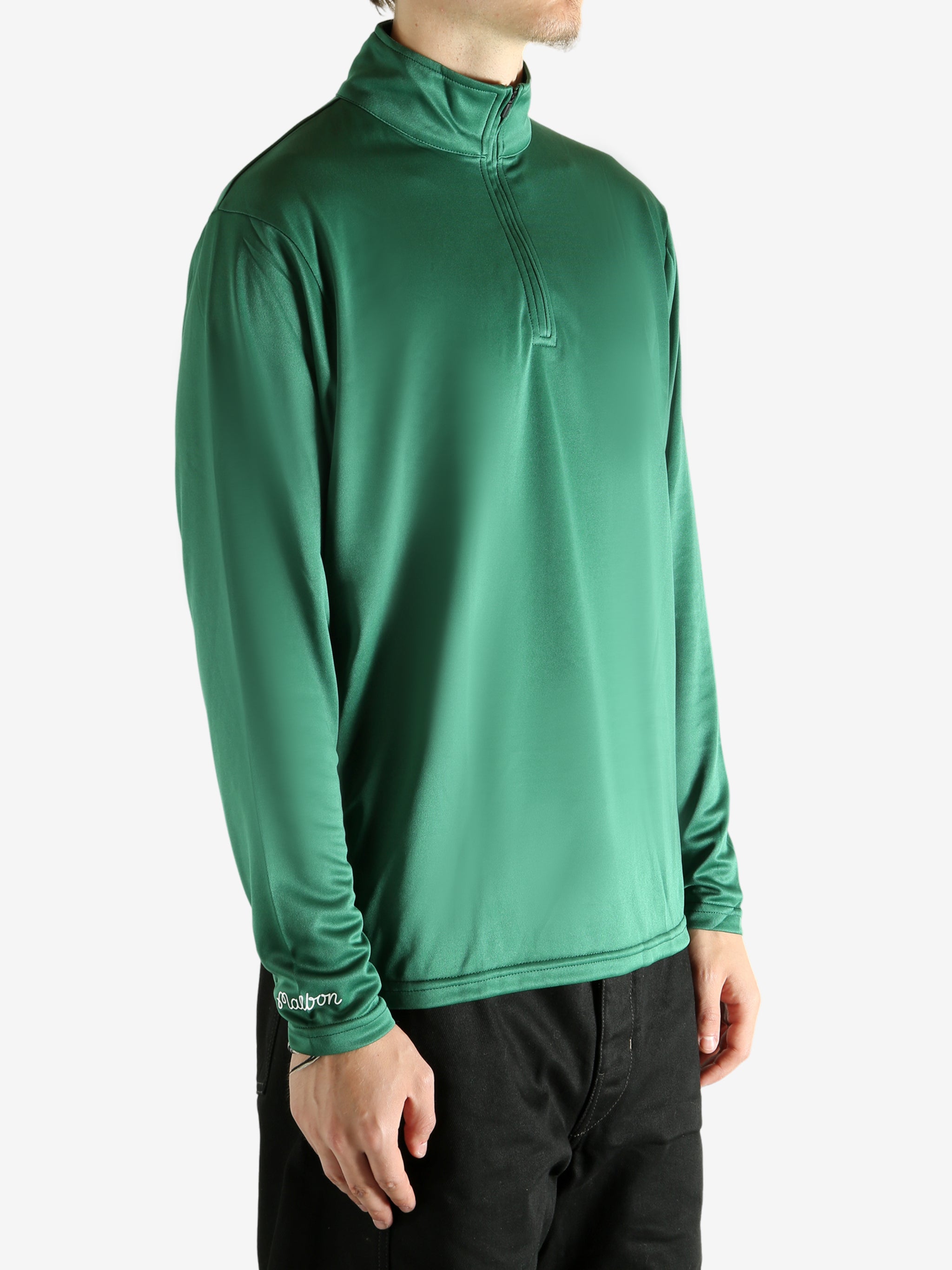 Green pullover worn by a person, showing the pullover's fit