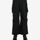 Black pants worn by a person, showing the pants's fit