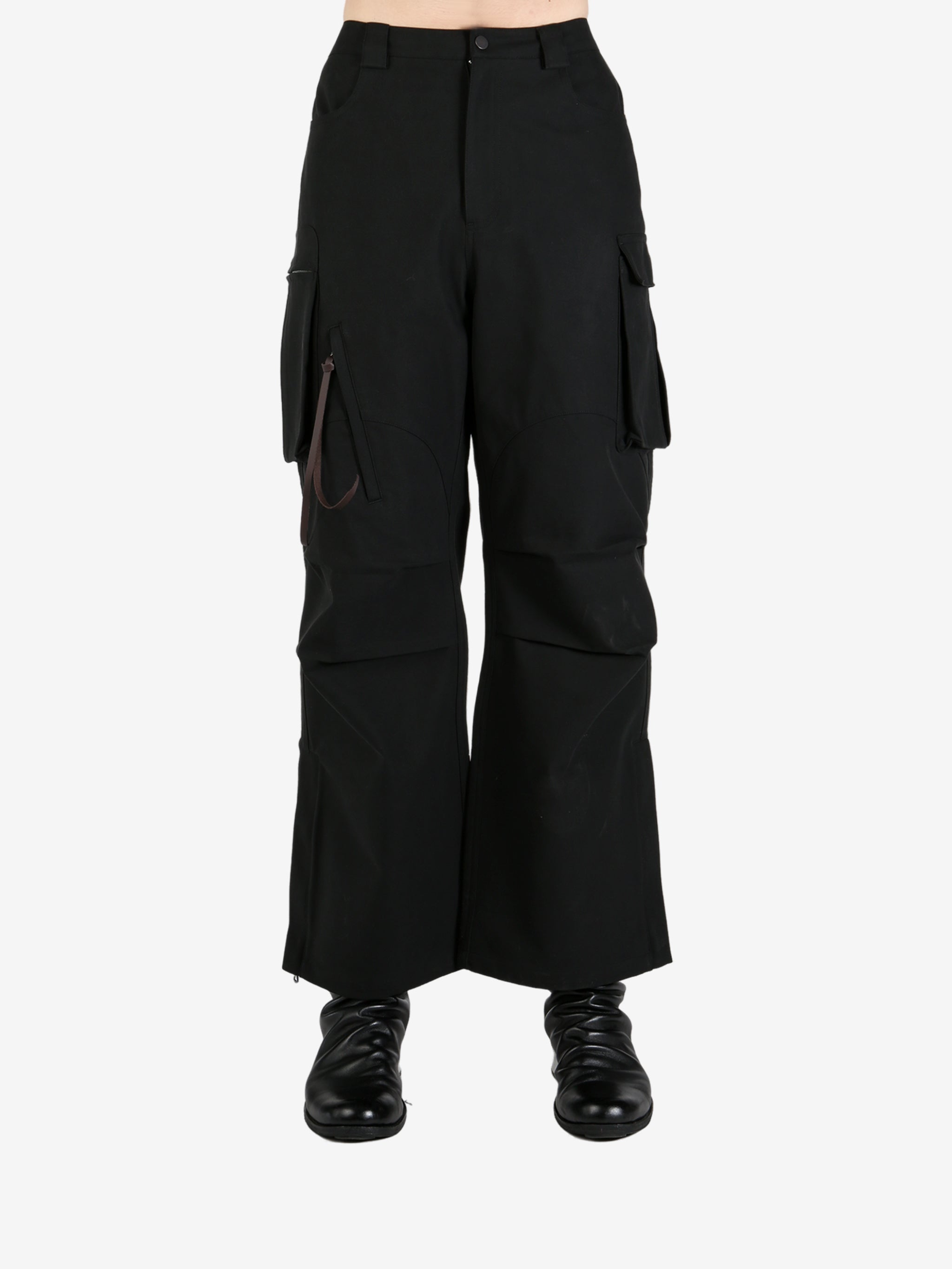 Black pants worn by a person, showing the pants's fit