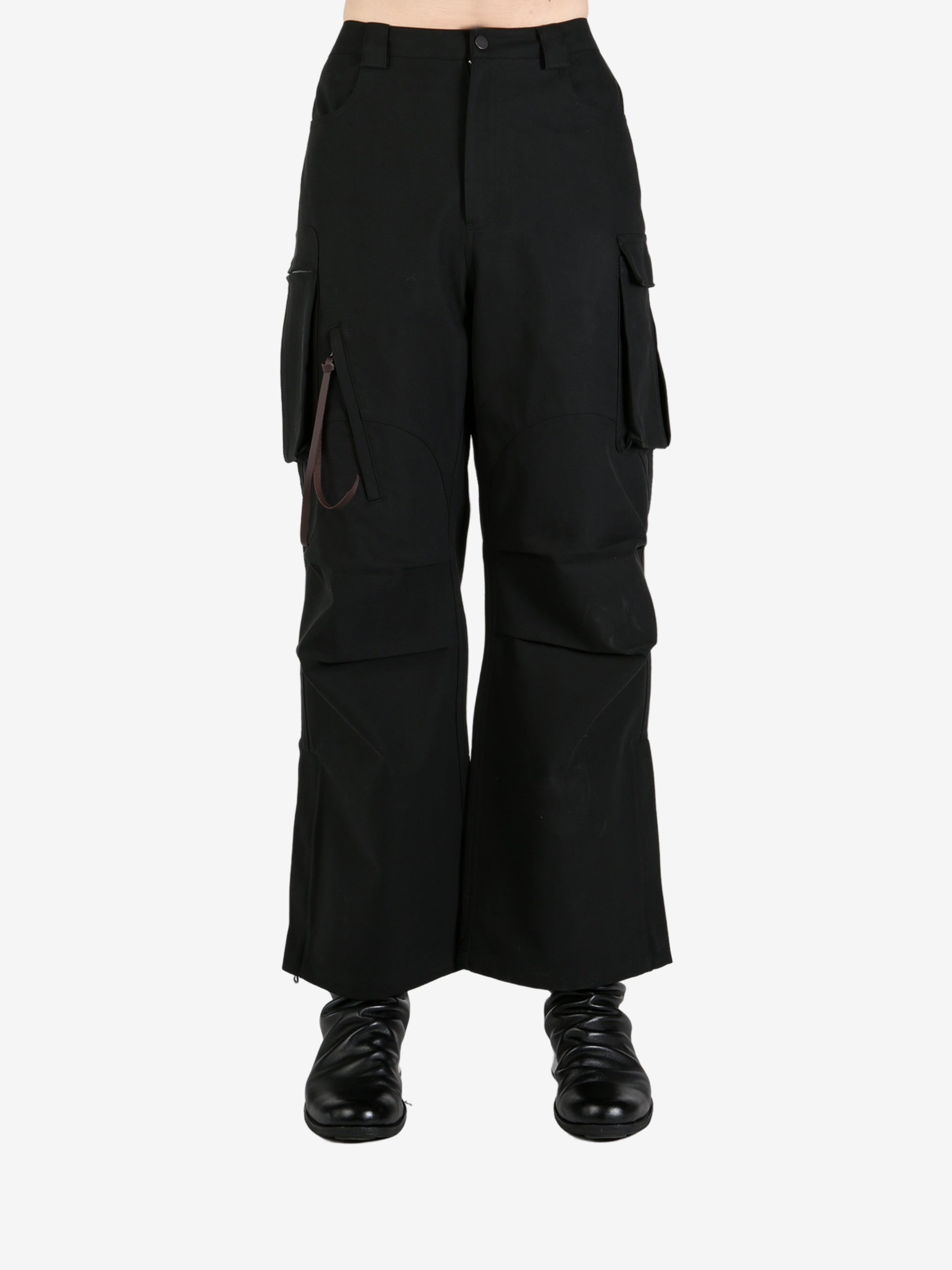 Black pants worn by a person, showing the pants's fit