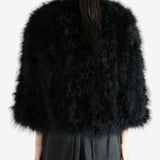 Black coat worn by a person, showing the coat's fit