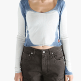 White long sleeve worn by a person, showing the tight fit.
