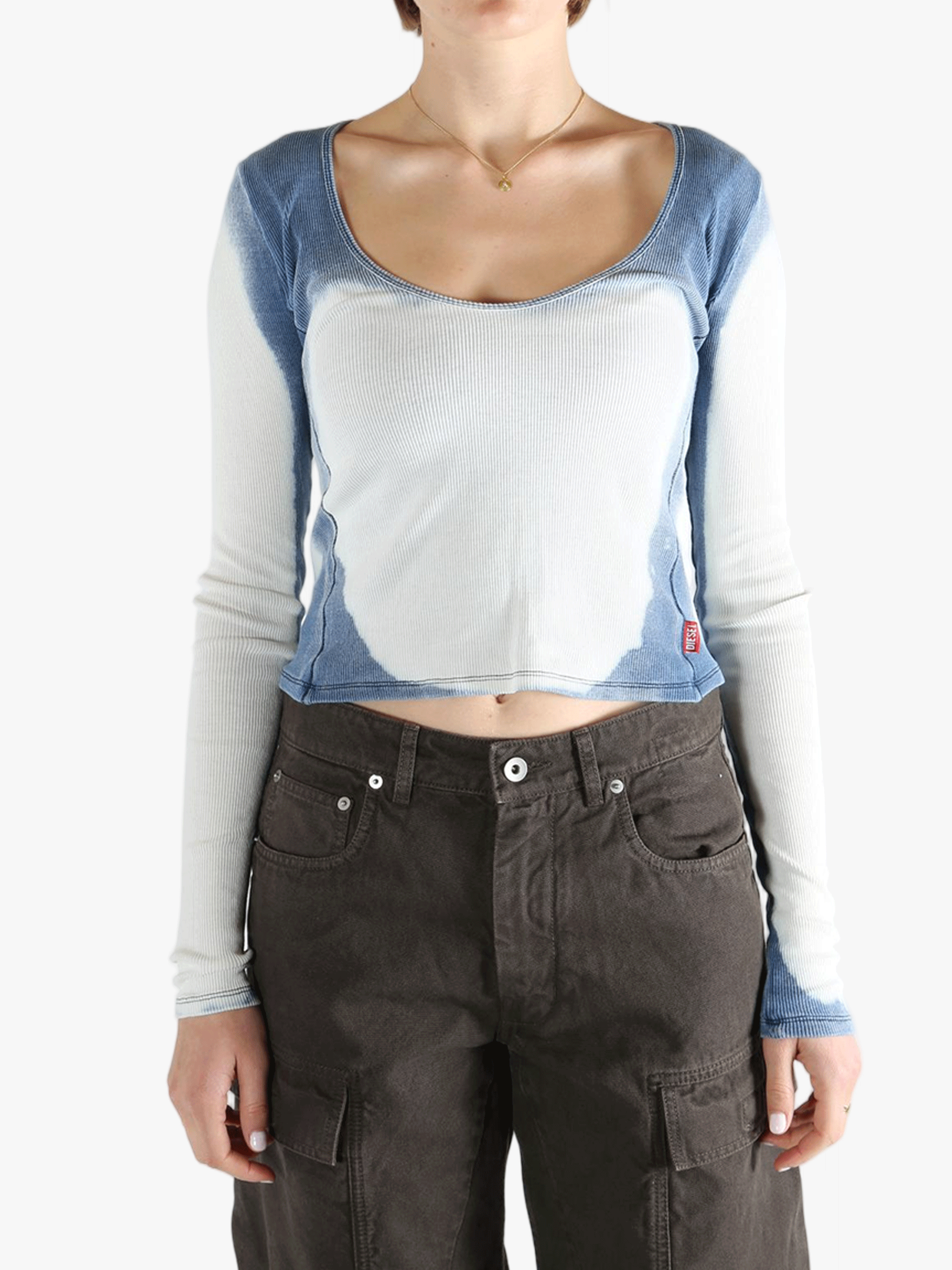 White long sleeve worn by a person, showing the tight fit.