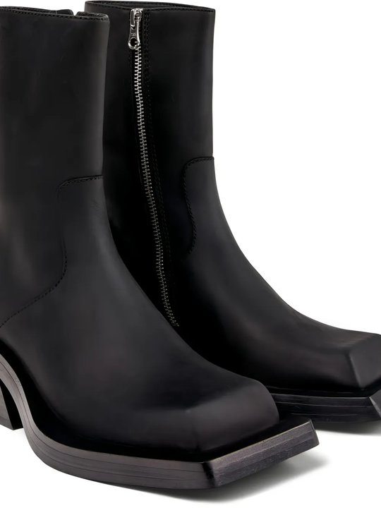 close up of black boots, showing texture of the  nubuck leather  fabric