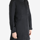 Black coat worn by a person, showing the coat fit