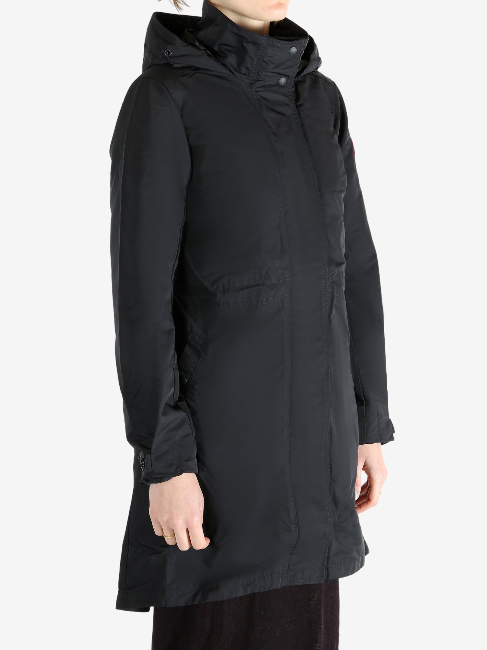 Black coat worn by a person, showing the coat fit