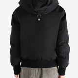 Black coat worn by a person, showing the coat fit