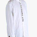 White shirt worn by a person, showing the shirt's fit