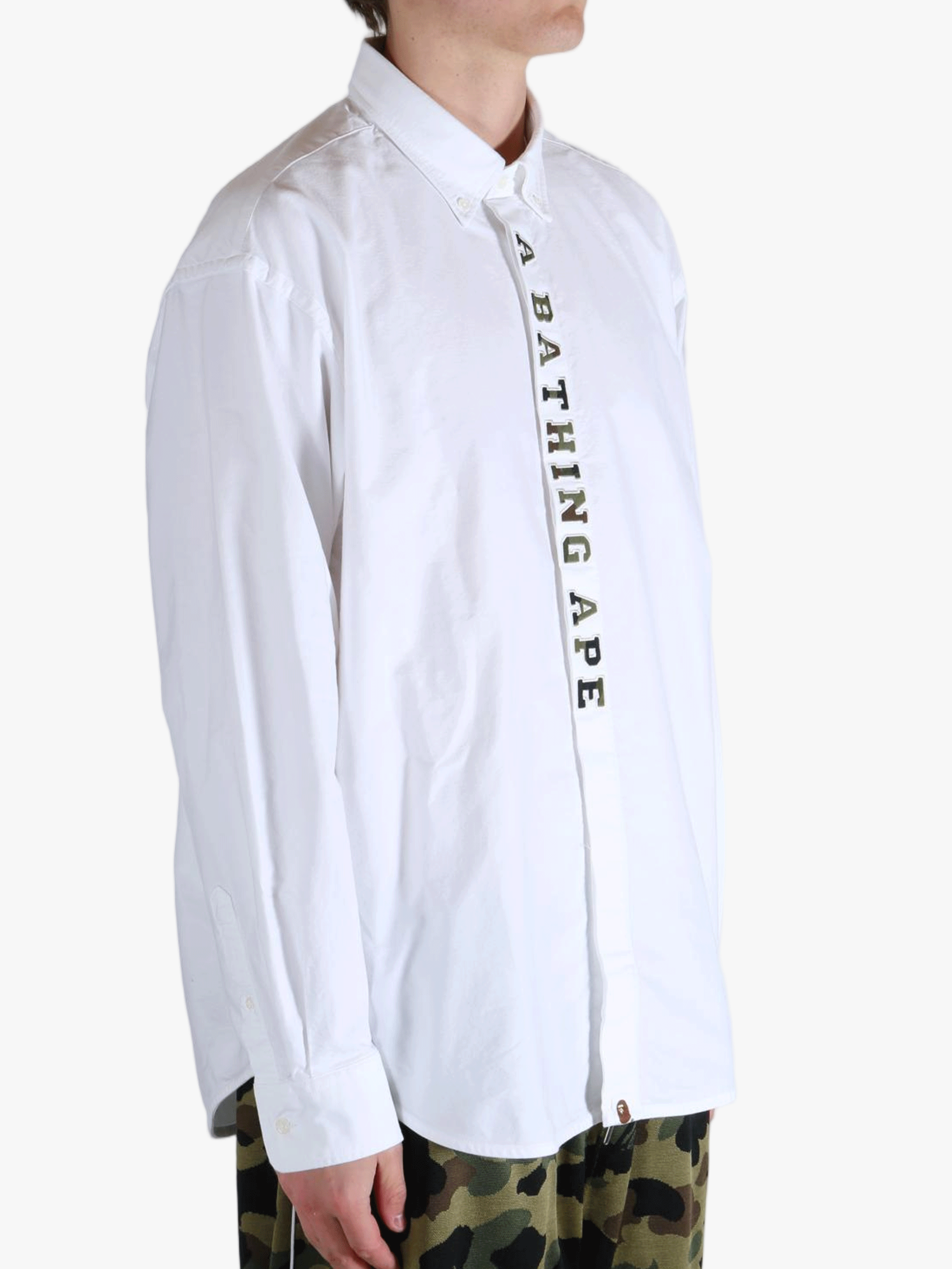 White shirt worn by a person, showing the shirt's fit