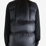 Black vest worn by a person, showing the vest  fit