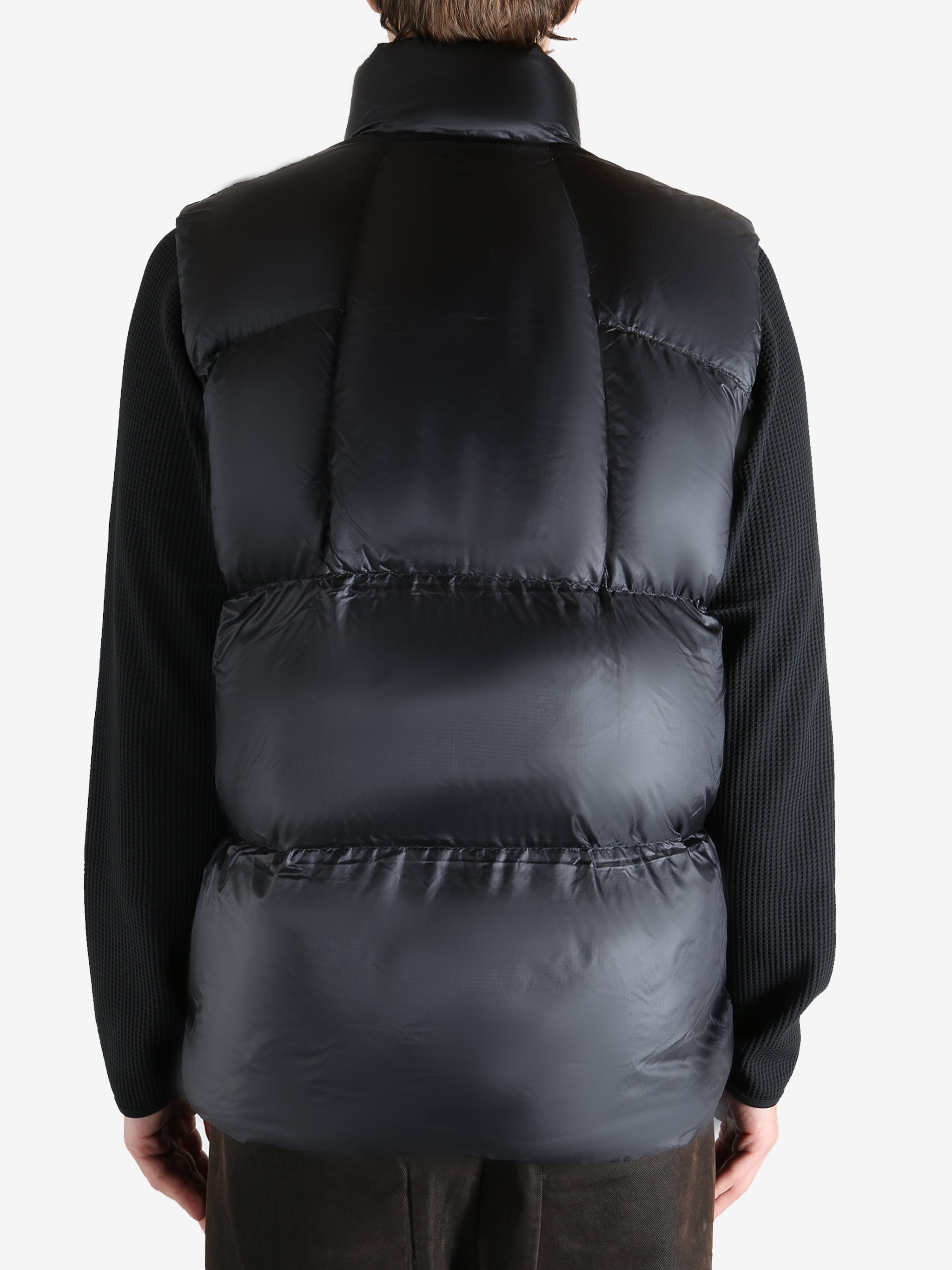 Black vest worn by a person, showing the vest  fit