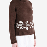 Brown knitwear worn by a person, showing the knitwear fit