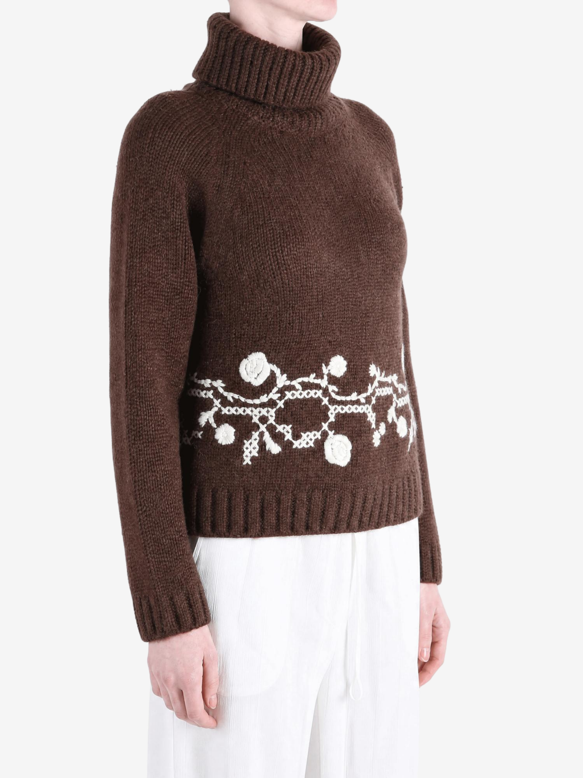 Brown knitwear worn by a person, showing the knitwear fit