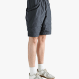 Gray shorts worn by a person, showing the short fit