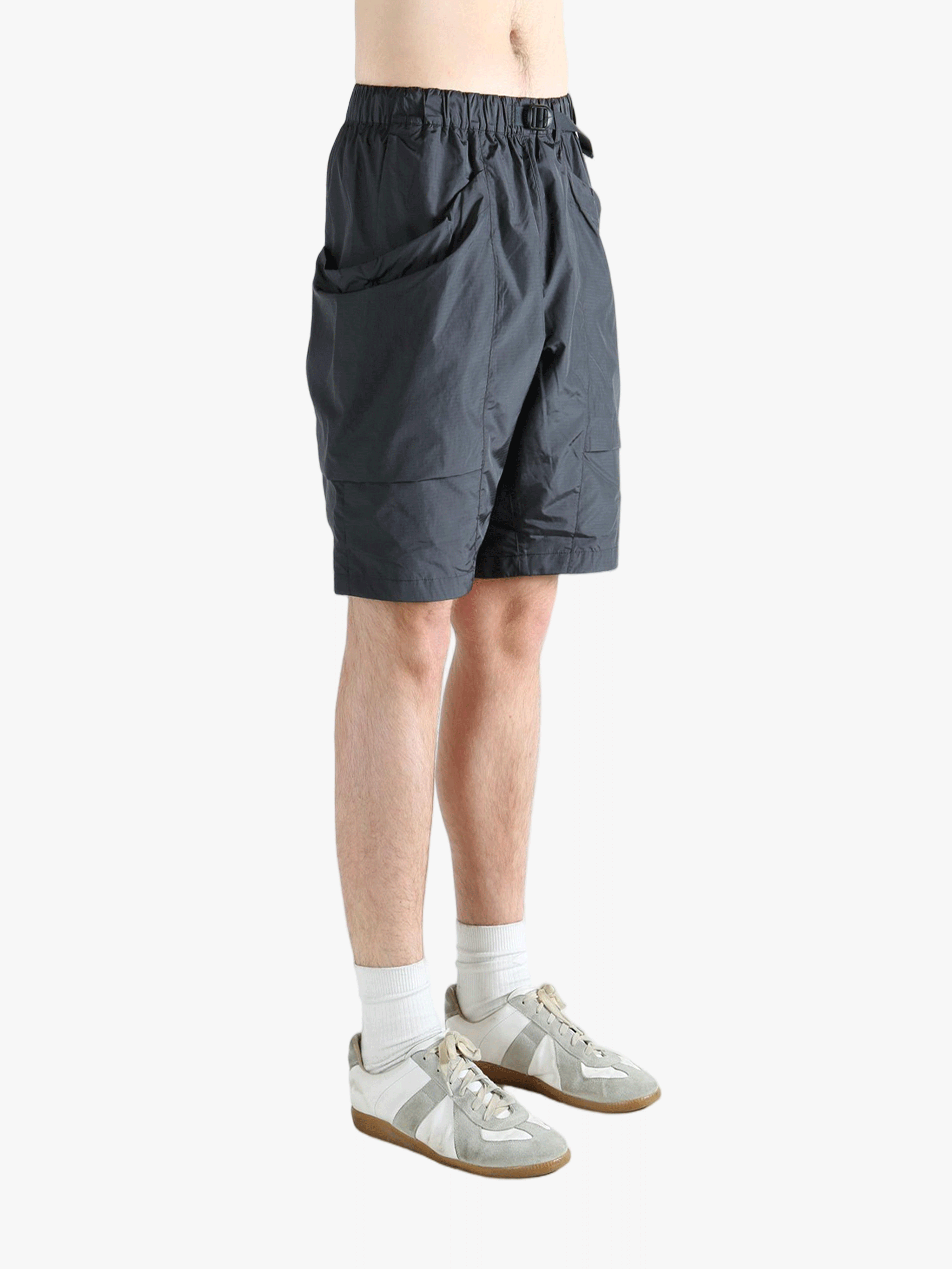Gray shorts worn by a person, showing the short fit