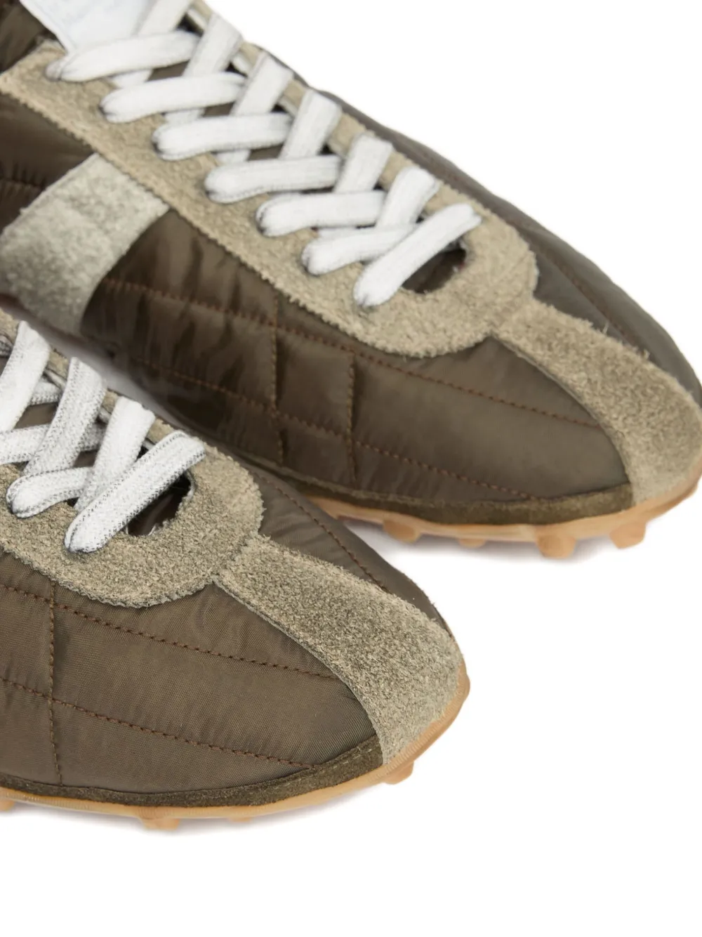 Close up of the grey sneakers, showing texture of the polyester and suede fabric