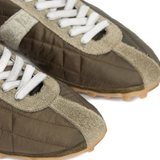 Close up of the grey sneakers, showing texture of the polyester and suede fabric