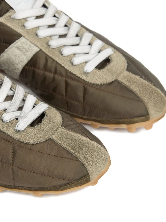 Close up of the grey sneakers, showing texture of the polyester and suede fabric