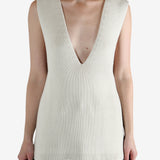 White top worn by a person, showing the top's fit