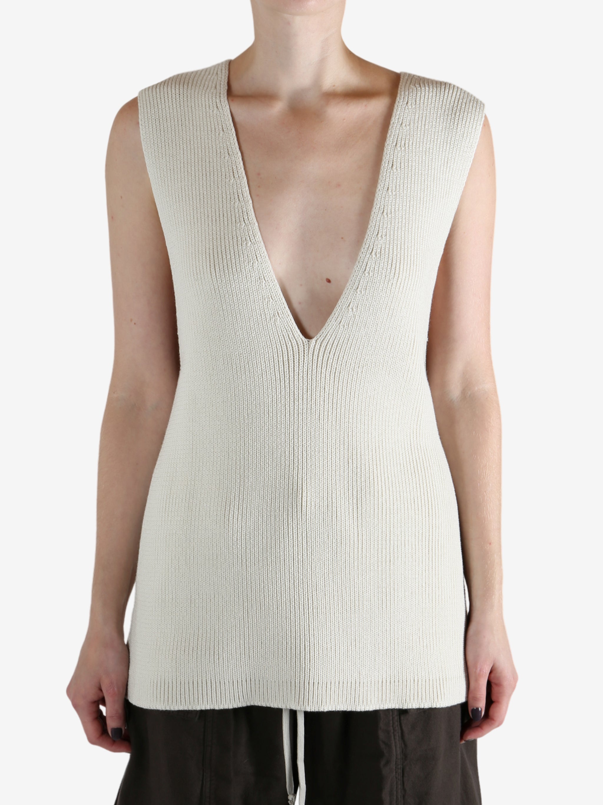 White top worn by a person, showing the top's fit