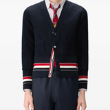 Black knitwear worn by a person, showing the knitwear fit