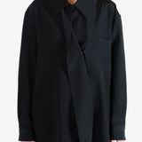 Black shirt worn by a person, showing the shirt's fit