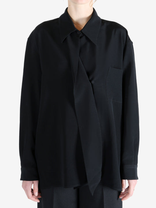 Black shirt worn by a person, showing the shirt's fit