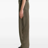 Green jeans worn by a person, showing the jeans' fit